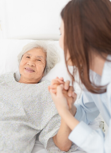 Elderly lady and nurse talking and smiling